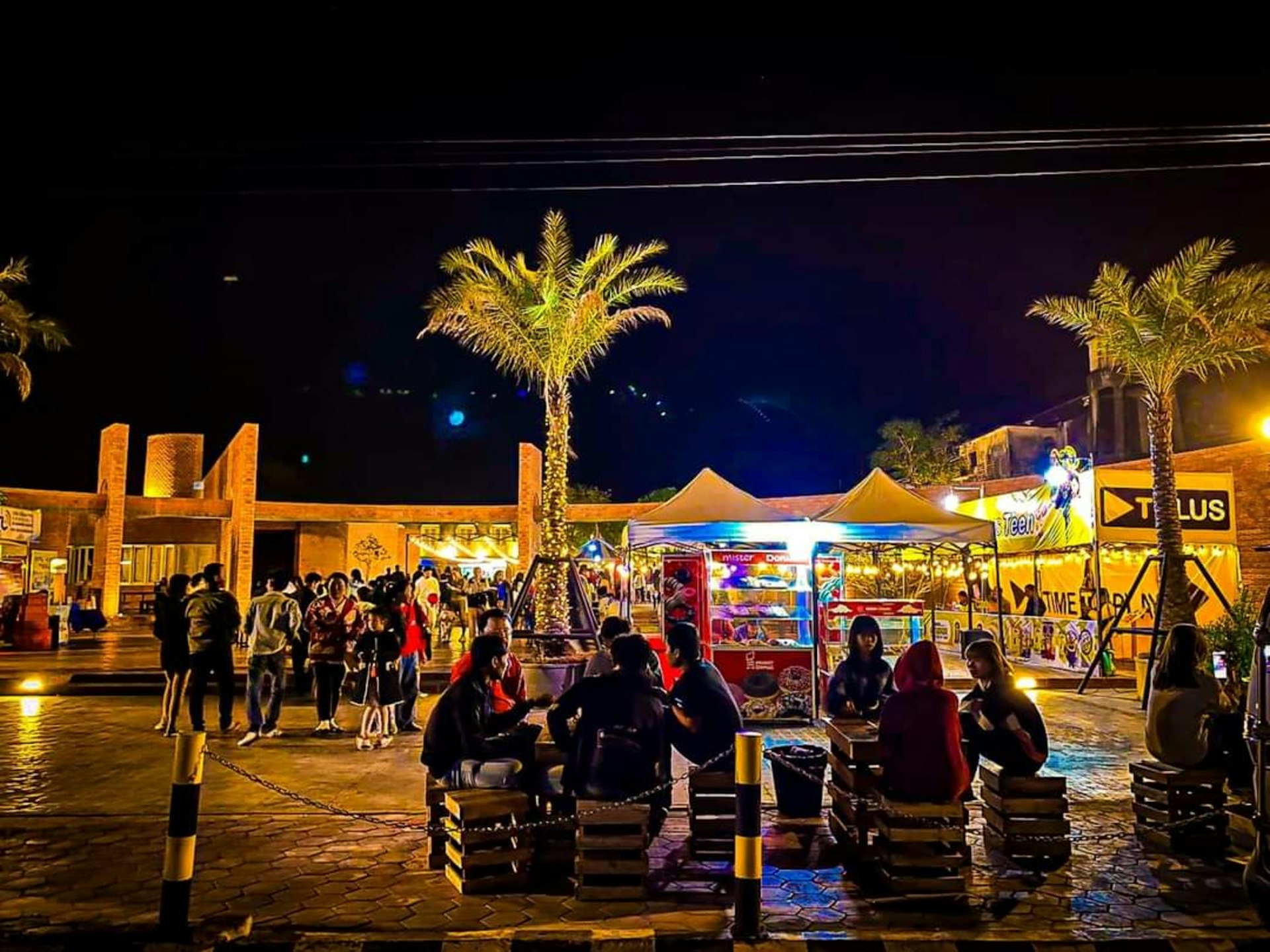 A group of people sitting on benches in front of a building